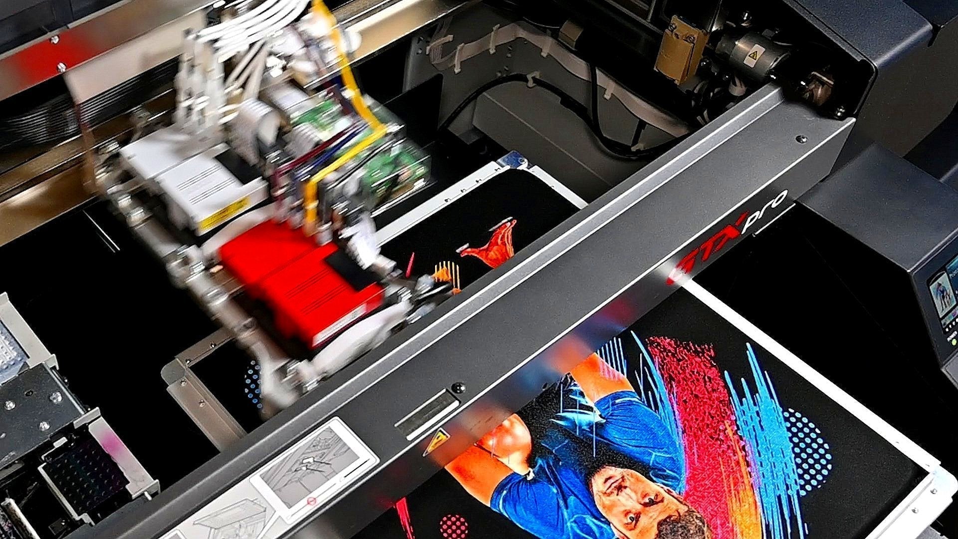 A professional DTG printer at Ink Nest Dallas applying a high-detail digital design directly onto a cotton t-shirt.